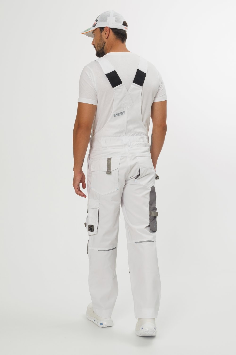 Rückansicht weiße Latzhose mit grauen Knieverstärkungen und vielen Taschen – strapazierfähige Arbeitslatzhose für Handwerker und Bau.