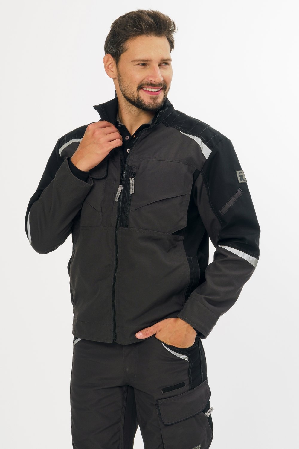Excess Workwear Arbeitsjacke in Schwarz mit Brusttaschen, Reißverschluss und reflektierenden Einsätzen für bessere Sichtbarkeit.